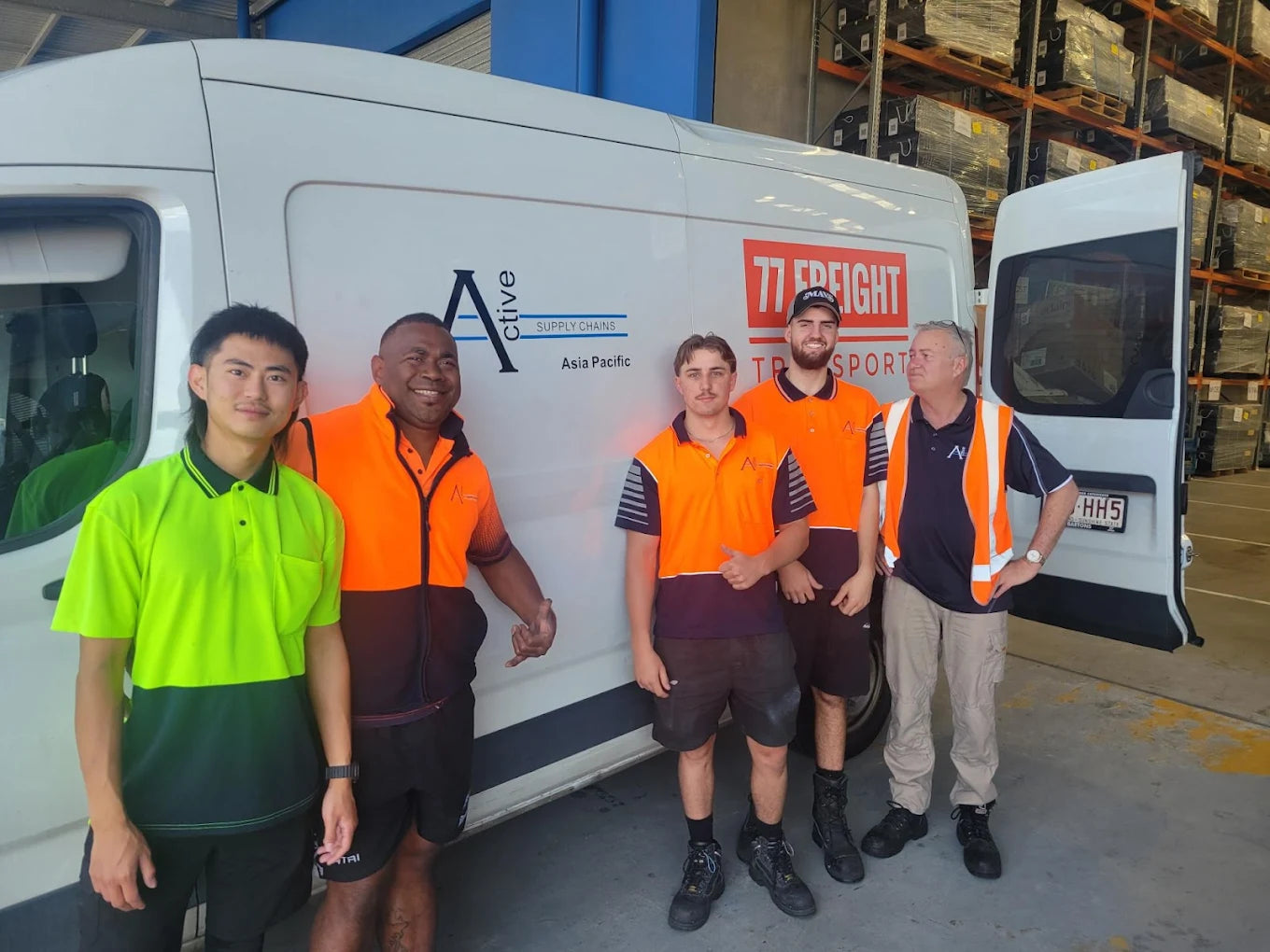 77 Freight Transport Brisbane delivery team standing beside company van at warehouse
