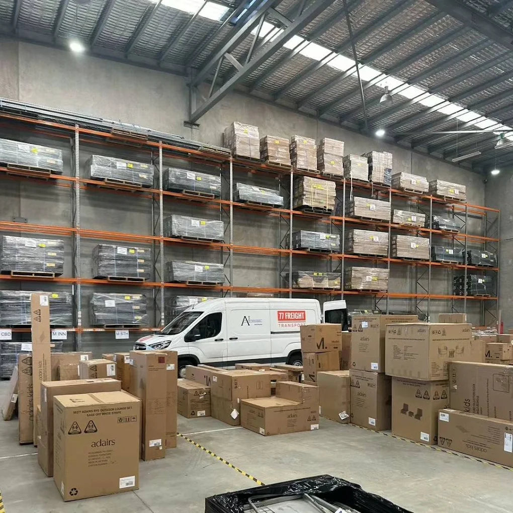 Warehouse in Brisbane with 77 Freight delivery van surrounded by packed boxes ready for dispatch