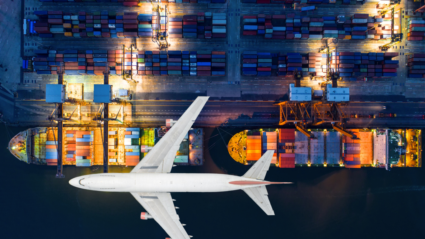 Aerial view of a container ship docked at a port with a plane superimposed on top.